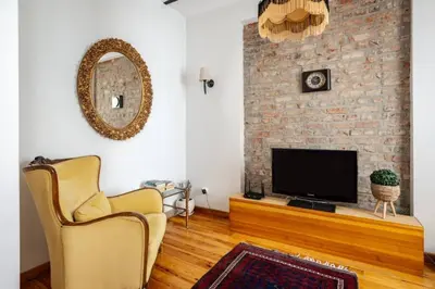 a living room with two chairs and a television at Authentic Galata Tower Central 2BD2Bath Home #411 in Istanbul