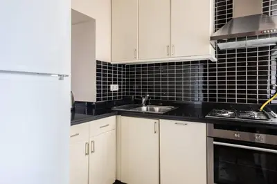 a kitchen with white cabinets and a sink at Galata Tower 2BD2Bath Authentic Gem! #412 in Istanbul