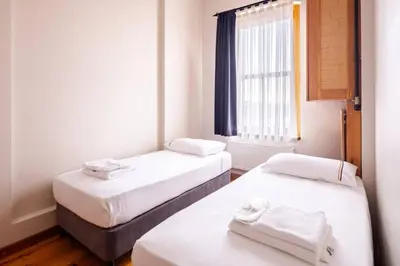 two beds in a small room with a window at Cool Authentic 2BD2Bath Galata Tower Home! #413 in Istanbul