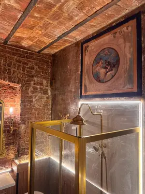 a bathroom with a glass shower with a painting on the wall at Allegory of Taksim in Istanbul