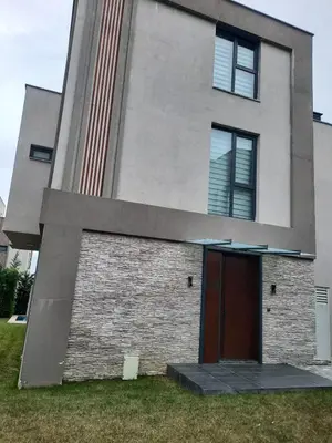 a building with a brown door in front of it at Villa with private pool for daily rent in Istanbul in Buyukcekmece