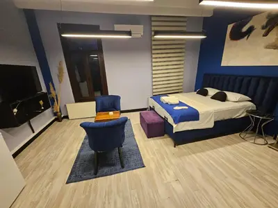 a bedroom with a bed and a chair at SARIKÖŞK HOTEL Kadıköy in Istanbul