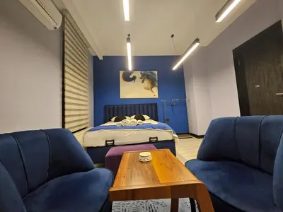 a room with two blue chairs and a bed at SARIKÖŞK HOTEL Kadıköy in Istanbul