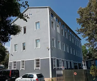 a gray building with cars parked in front of it at Akademik Pansiyon in Istanbul