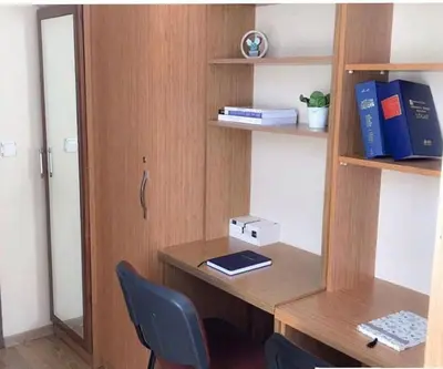 a desk with a chair and a book shelf at Akademik Pansiyon in Istanbul