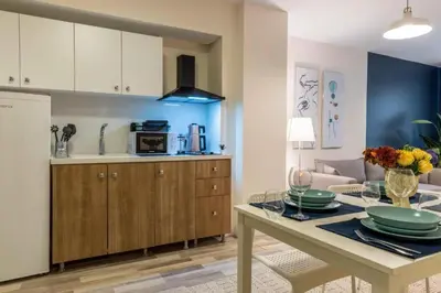 a kitchen and living room with a table and a couch at Taksim Square - Apartment - Sleeps 4 - City Centre in Istanbul