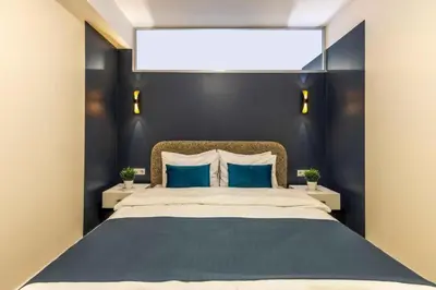 a bedroom with a large bed with blue walls at Taksim Square - Apartment - Sleeps 4 - City Centre in Istanbul