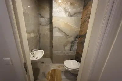 a bathroom with a toilet and a sink at Gold Suit - Bakırköy City Center in Istanbul