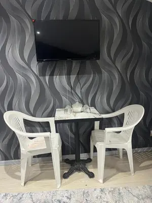 a desk with two chairs and a television on a wall at Taksim Nova House hotel in Istanbul