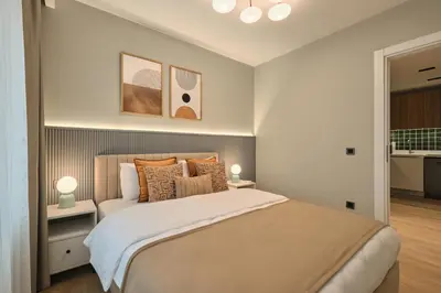 a bedroom with a large bed and two lamps at BSY Flats Well Decorated Modern Apartments With 2BR, 3BR Options in Istanbul