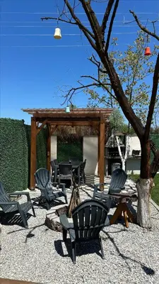 a group of chairs and a picnic shelter with a tree at Melodi Bungalov Sapanca in Sakarya