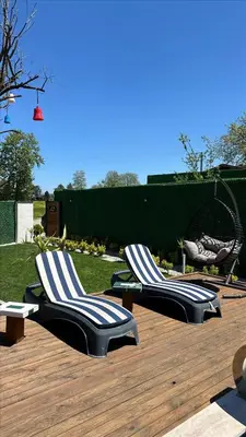 two lounge chairs sitting on a wooden deck at Melodi Bungalov Sapanca in Sakarya