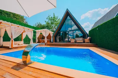 a swimming pool with a waterfall in a house at Melodi Bungalov Sapanca in Sakarya