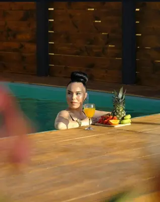 a woman in a swimming pool with a glass of wine at Sapanca Balkaya Bungalov in Sapanca