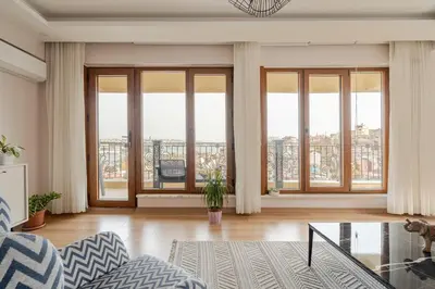 a living room with large windows and a view of a city at New Stylish Apartment with Panoramic Views in Istanbul