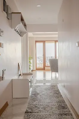 a living room with white walls and a rug at New Stylish Apartment with Panoramic Views in Istanbul