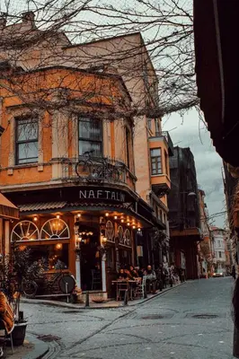 a street with a cafe in front of a building at New Stylish Apartment with Panoramic Views in Istanbul