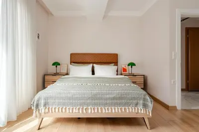 a bedroom with a large bed and two night stands at New Stylish Apartment with Panoramic Views in Istanbul