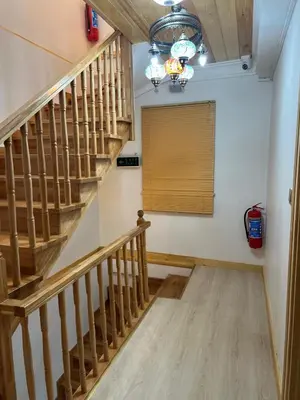 a hallway with wooden stairs and a window with a shutter at Arkeon Bosphorus Hotel & Suites in Istanbul