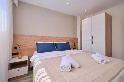 a bedroom with a large white bed with blue pillows at BSY's Stylish 1BR,2BR ,3BR Apartments in Brand New Building in Istanbul