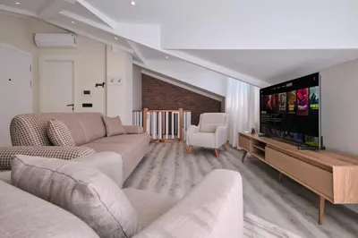 a living room with couches and a flat screen tv at BSY's Stylish 1BR,2BR ,3BR Apartments in Brand New Building in Istanbul