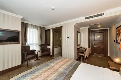 a hotel room with a bed and a desk at The Central Hotel in Istanbul