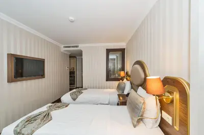 a hotel room with two beds and a television at The Central Hotel in Istanbul