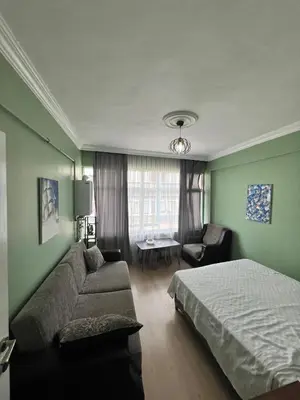 a bedroom with a bed and a couch and a table at Meryy Home in Istanbul