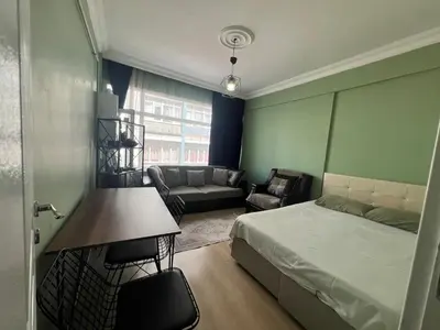 a bedroom with a bed and a living room at Meryy Home in Istanbul