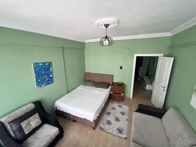 a bedroom with a bed and a couch and a chair at Meryy Home in Istanbul