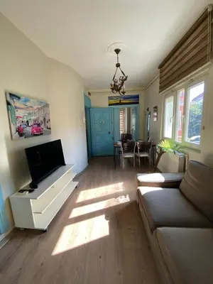a living room with a couch and a flat screen tv at Taxim Sofa Suites in Istanbul