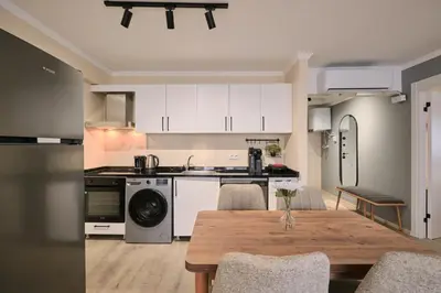 a kitchen and dining room with a wooden table at House Kadıköy in Istanbul