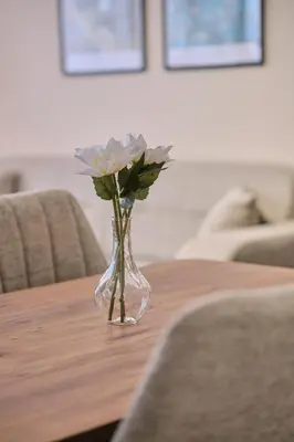 a vase with flowers sitting on a table at House Kadıköy in Istanbul