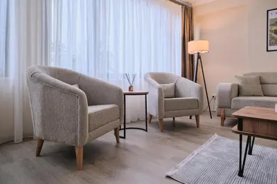 a living room with two chairs and a table at House Kadıköy in Istanbul