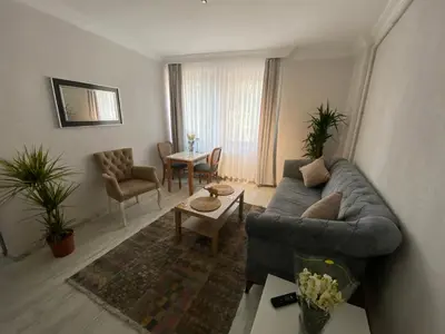a living room with a couch and a table at ŞAH apartmanı in Istanbul