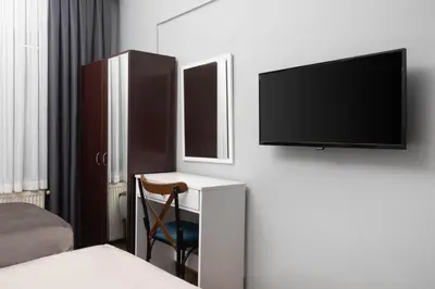 a bedroom with a desk with a tv and a chair at Galey Pört in Istanbul