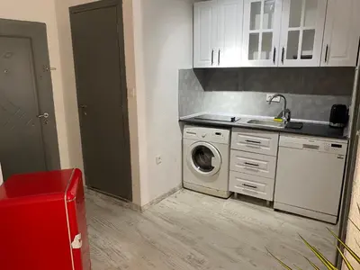 a kitchen with a washing machine and a sink at Şah in Istanbul