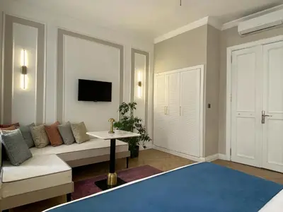 a living room with a couch and a tv at Vion Hotel Taksim in Istanbul