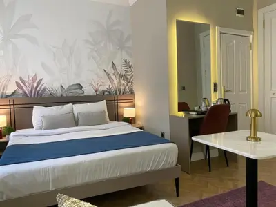 a bedroom with a bed and a desk and a table at Vion Hotel Taksim in Istanbul