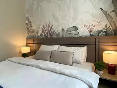 a bedroom with a large white bed with two lamps at Vion Hotel Taksim in Istanbul