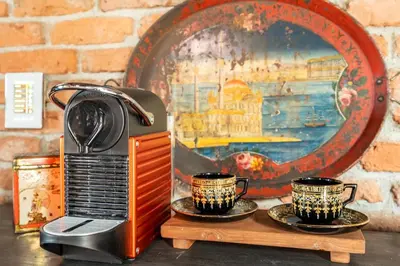 a toaster and two cups sitting on a table at NOLD Suite in Istanbul