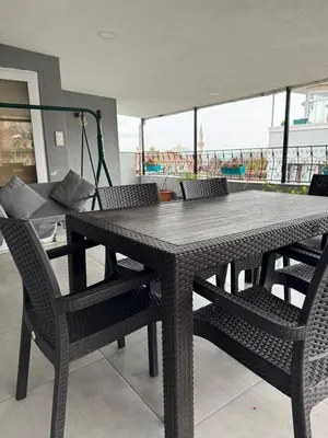 a black table and chairs in a living room at Blue Mosq Pansiyon & Apart in Istanbul