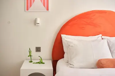 a bedroom with a bed with an orange headboard at Cihangir Pop Art Hideaway in Istanbul