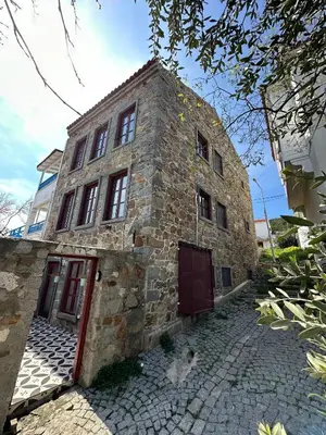 an old stone house with a cat sitting outside of it at Nefes Ada Taş Bina - Bahçe Katı in Istanbul