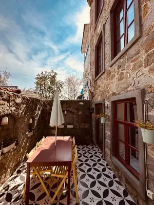 a patio with a table and umbrella on a building at Nefes Ada Taş Bina - Bahçe Katı in Istanbul
