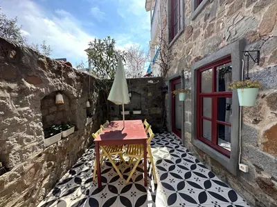 a patio with a table and an umbrella at Nefes Ada Taş Bina - Bahçe Katı in Istanbul