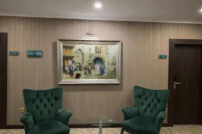 a waiting room with two chairs and a painting on the wall at Akgün Hotel Laleli Istanbul in Istanbul