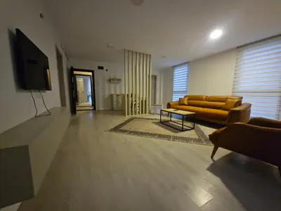 a living room with a couch and a tv at Suiton6 apart otel in İhsaniye