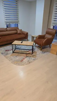 a living room with two couches and a coffee table at Suiton6 apart otel in İhsaniye