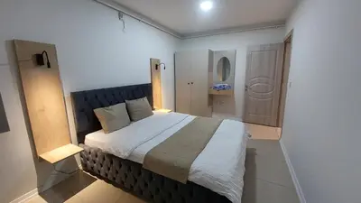 a bedroom with a large bed in a room at Suiton6 apart otel in İhsaniye